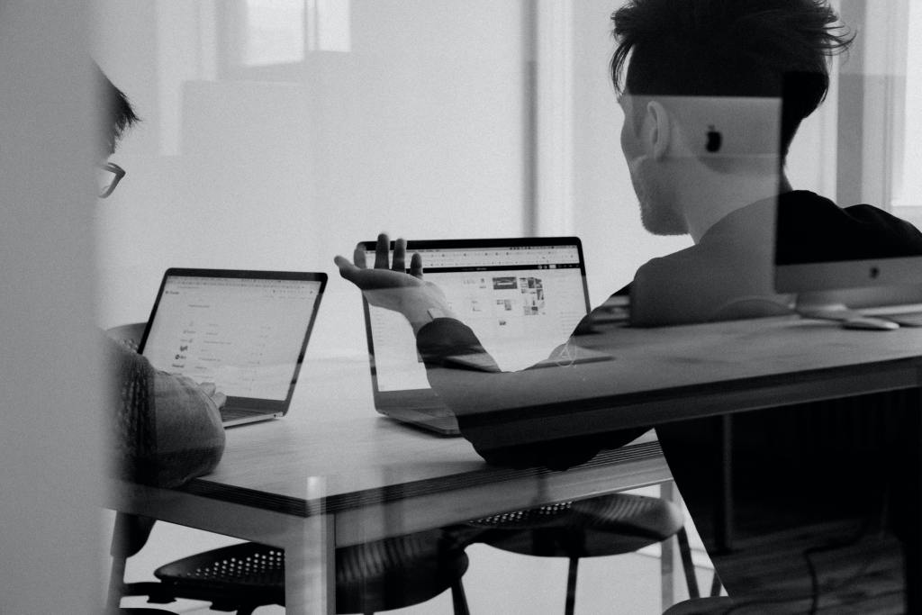 men collaborating with laptops