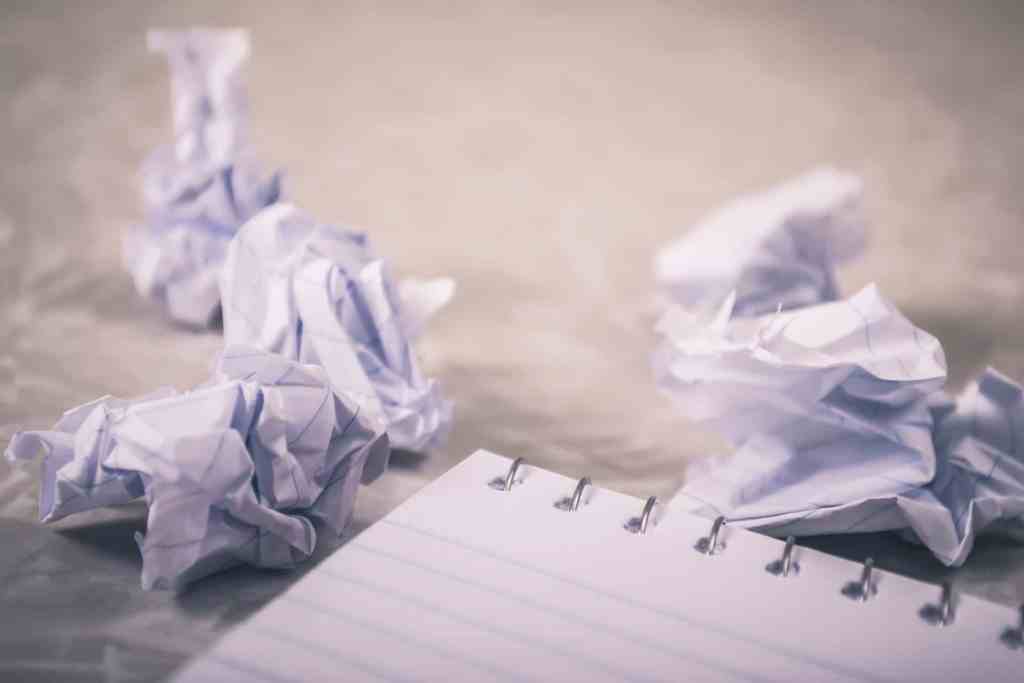 crumpled up paper and a notebook