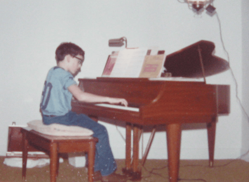 Phil practicing piano aged 11